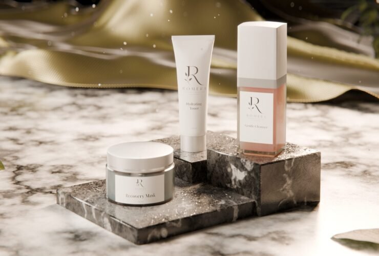 3D render of a skincare trio (jar, tube and bottle) on marble pedestals